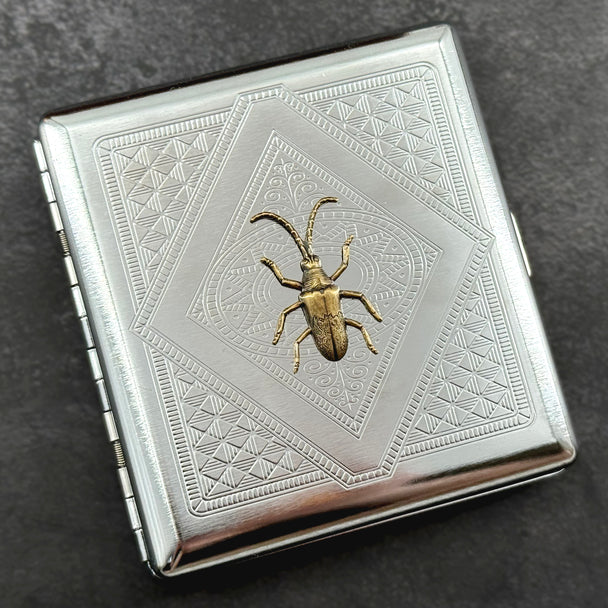 Victorian-inspired beetle pocket case featuring an ornate geometric stamped pattern