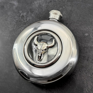 Close-up of raised longhorn skull detail in the transparent flask window