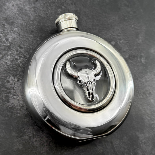 Mirror-finish 5 oz hip flask featuring a silver-toned bull skull centerpiece