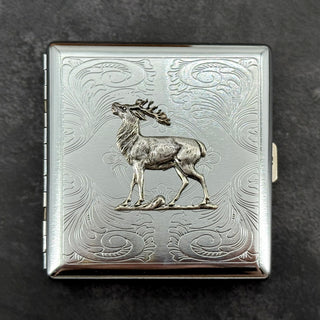 Close-up of raised elk embellishment on a handcrafted silver metal case