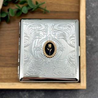 Midnight Rose cigarette case featuring framed rose design on engraved silver metal case