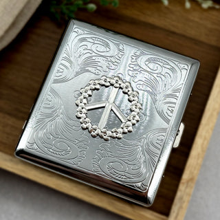 Peace & Petals cigarette case featuring floral peace sign design on engraved silver metal case