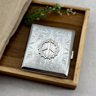 Floral peace symbol card holder with engraved metal finish and secure snap closure