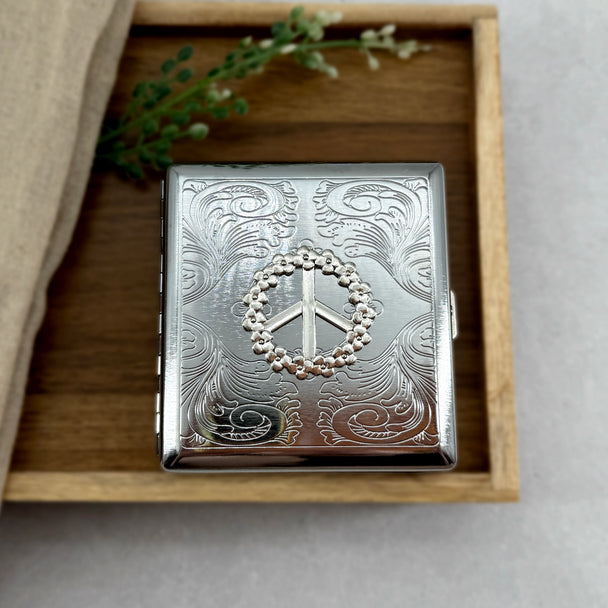 Retro-inspired cigarette case featuring flower power peace sign design