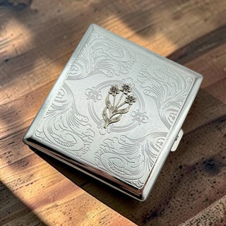 Handcrafted floral cigarette case and card holder with raised flower design and decorative metal finish