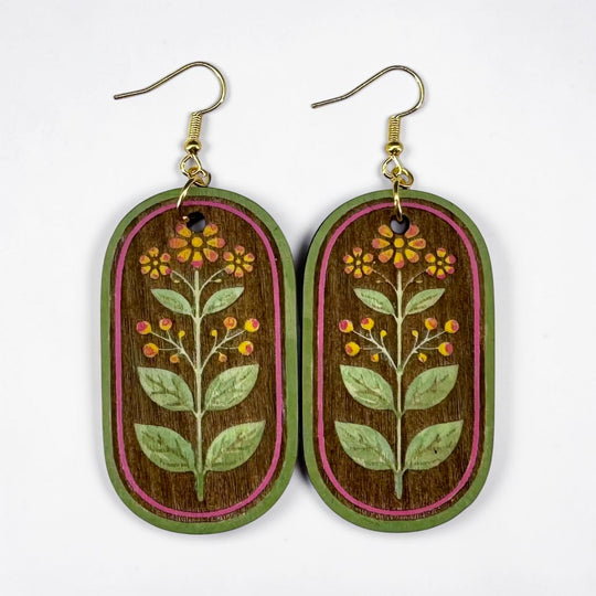 Wooden earrings with floral design on a white background