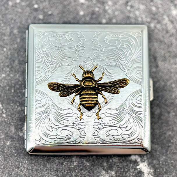 Handmade Queen Bee cigarette case featuring raised golden bee design with engraved ornamental background