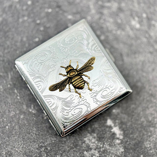 Decorative Queen Bee cigarette case with raised bee motif and engraved vintage-inspired detailing
