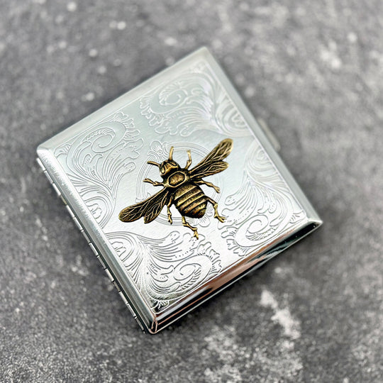 Decorative Queen Bee cigarette case with raised bee motif and engraved vintage-inspired detailing