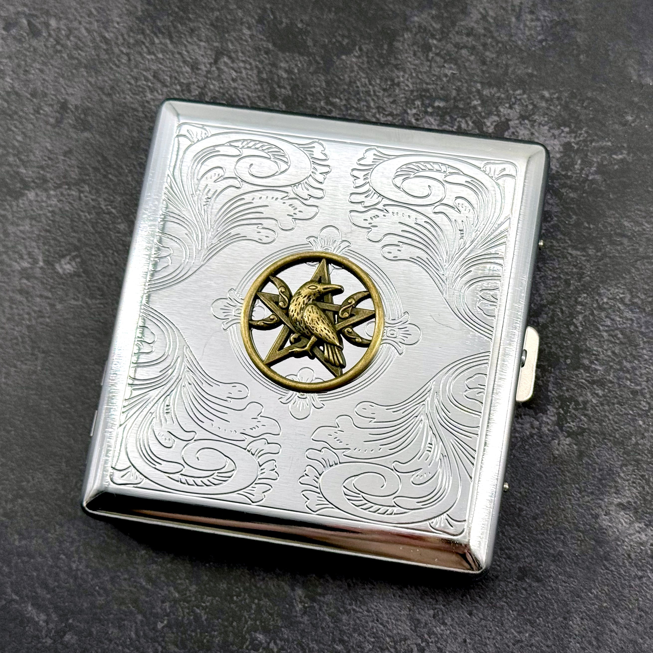 Gothic raven cigarette case with celestial pentacle detail and ornate engraved finish