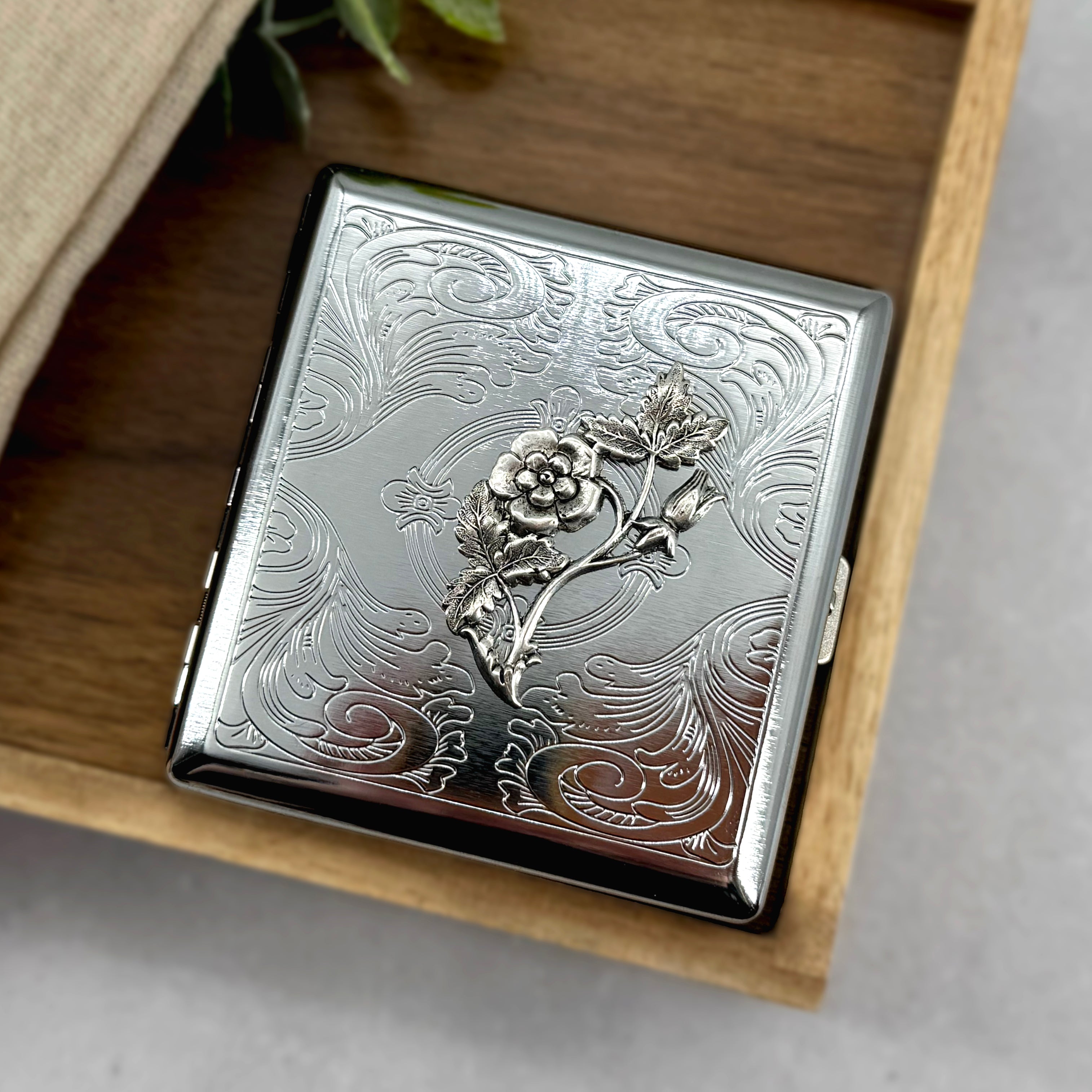 Handmade botanical cigarette case with flower and leaf embellishment