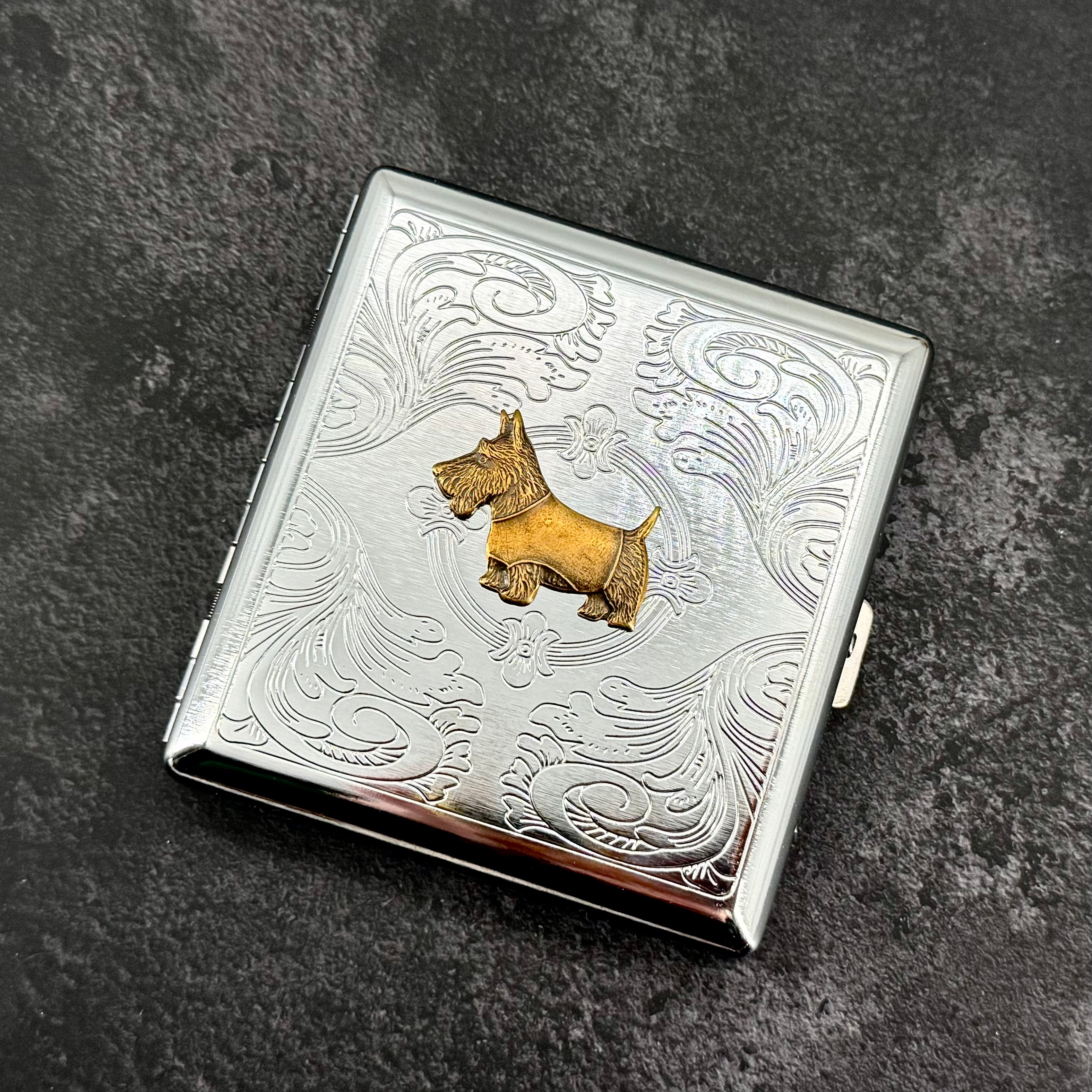 Open Scottie dog cigarette case showing interior storage for cigarettes cards or cash