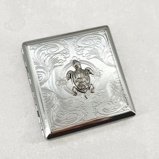 Open sea turtle cigarette case showing interior storage for cigarettes cards or cash