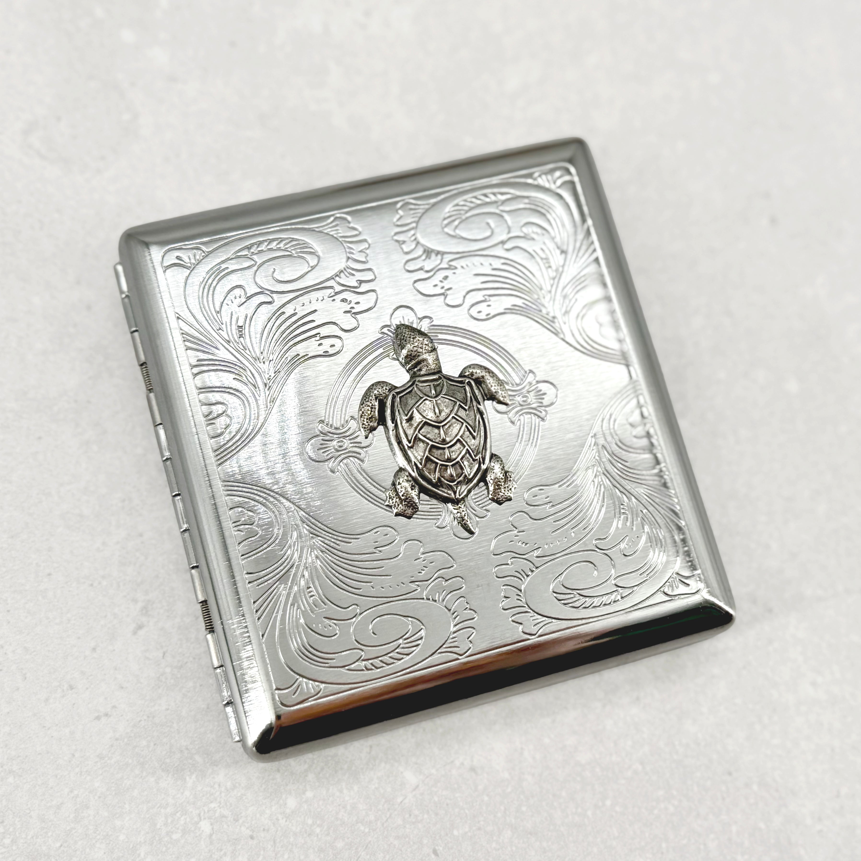 Open sea turtle cigarette case showing interior storage for cigarettes cards or cash
