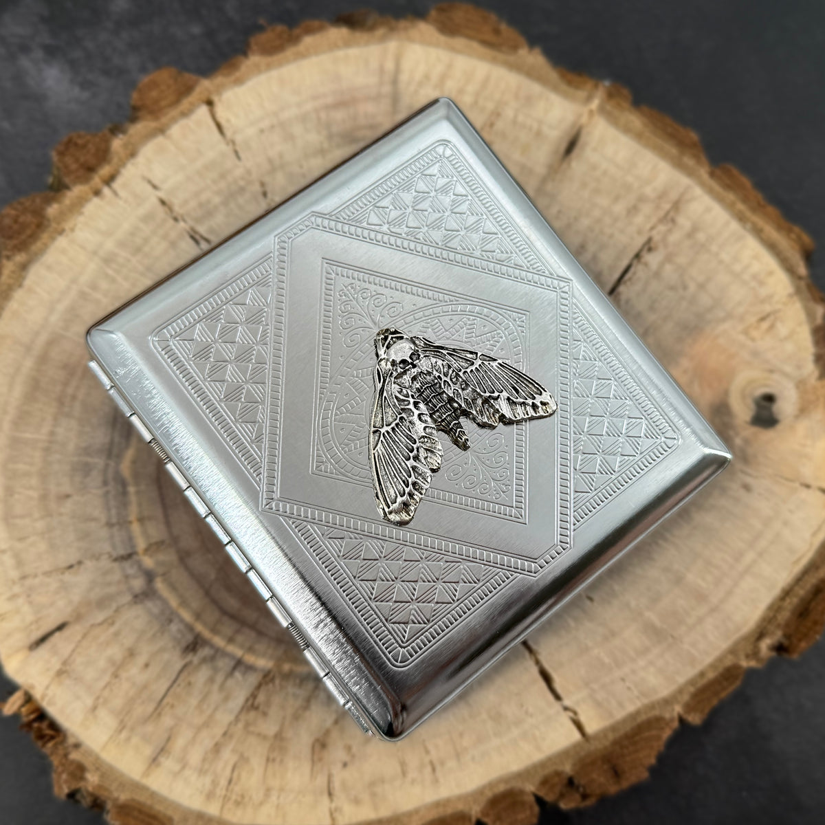 Gothic cigarette case featuring a silver death’s-head moth centerpiece