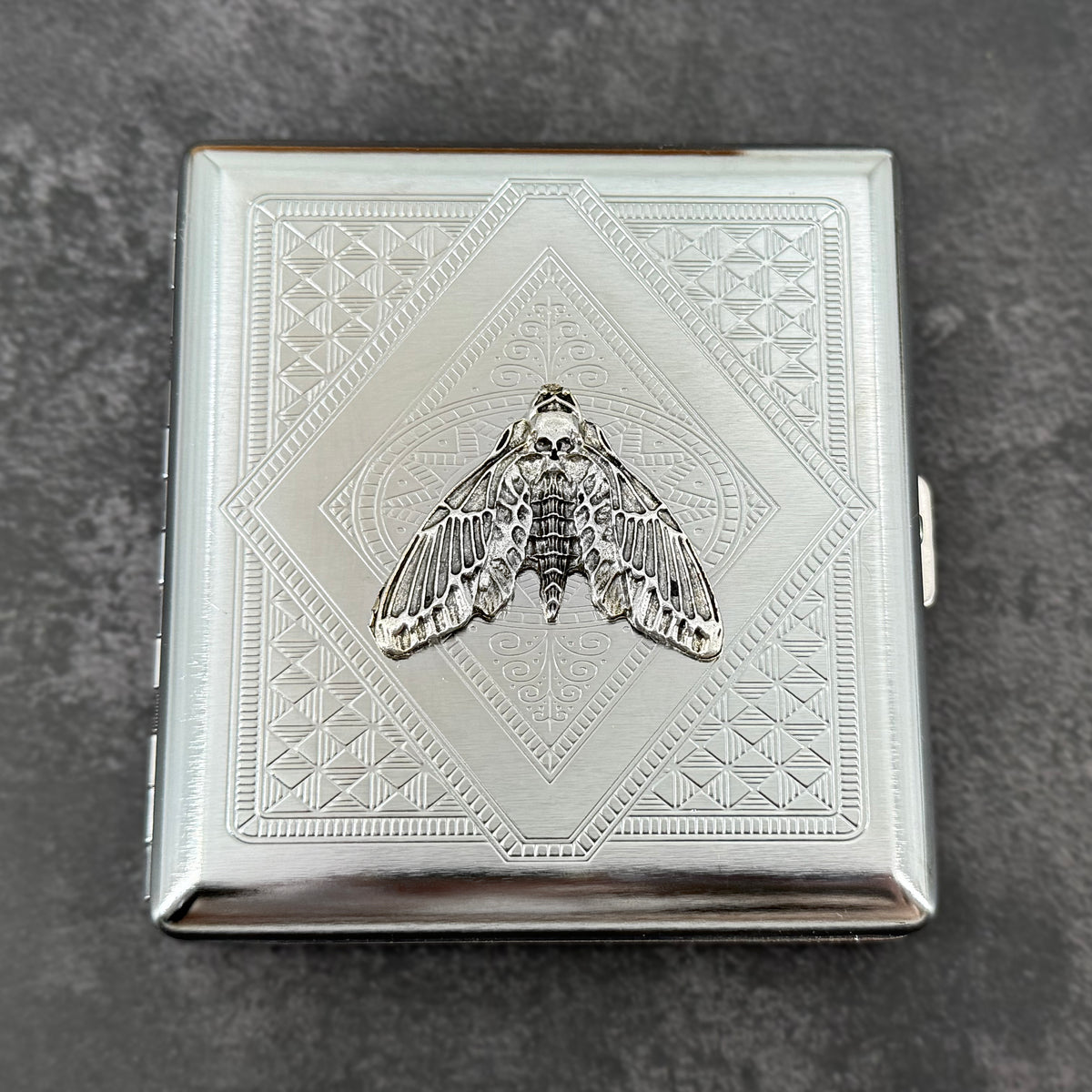 Gothic silver card holder featuring a detailed skull moth centerpiece