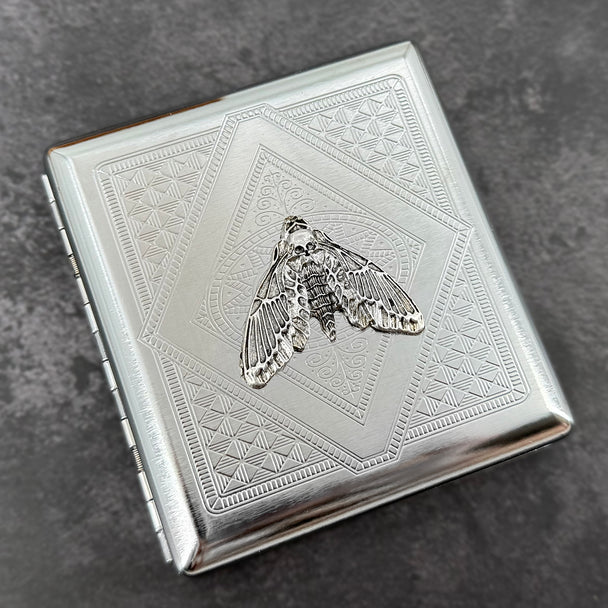 Handmade metal card holder with skull moth design and stamped silver finish