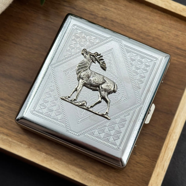 Silver-toned metal card holder featuring a detailed elk over layered geometric patterns