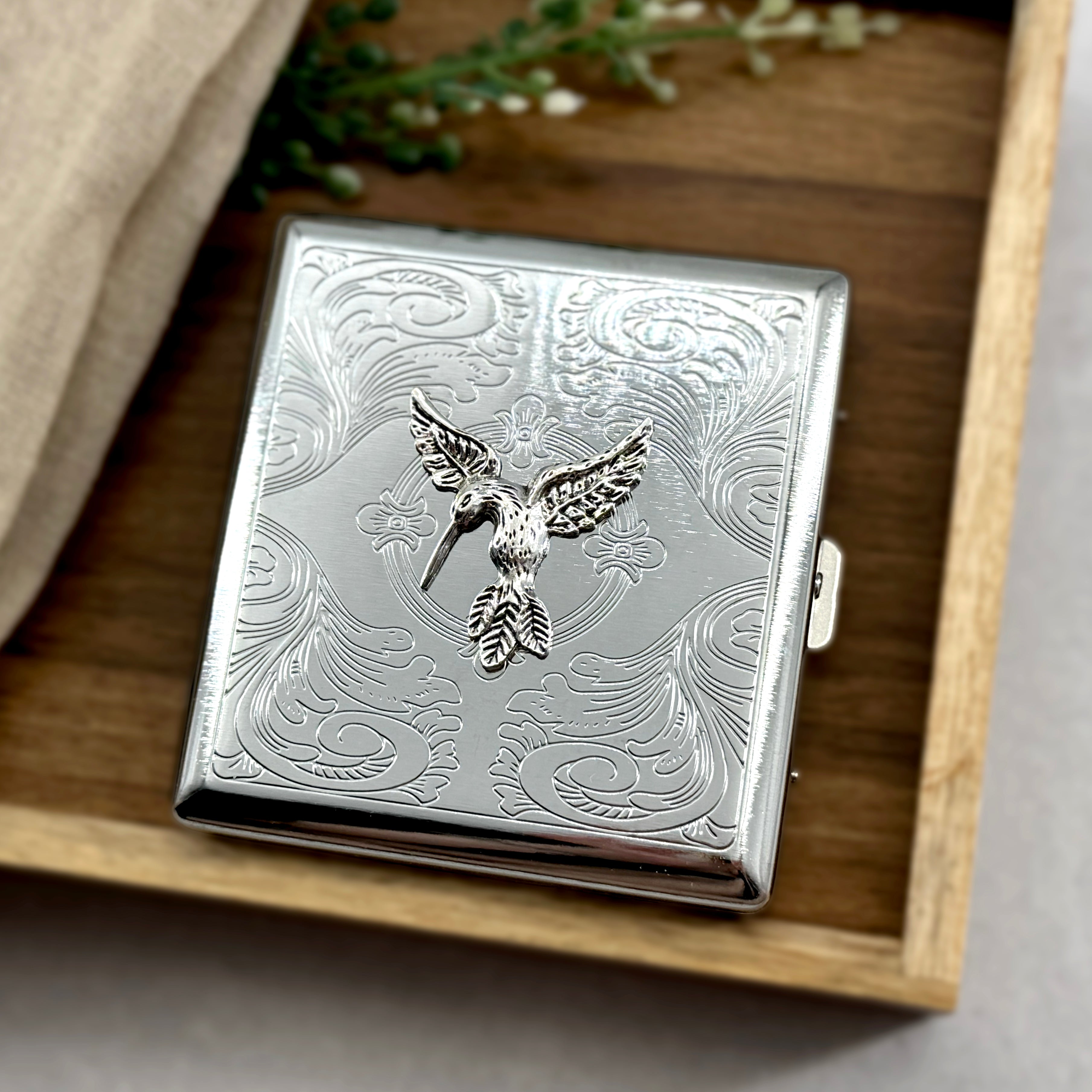 Handmade hummingbird cigarette case with ornate scrollwork detailing and nature-inspired styling