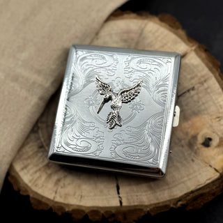 Hummingbird card holder featuring detailed bird design on engraved silver metal case
