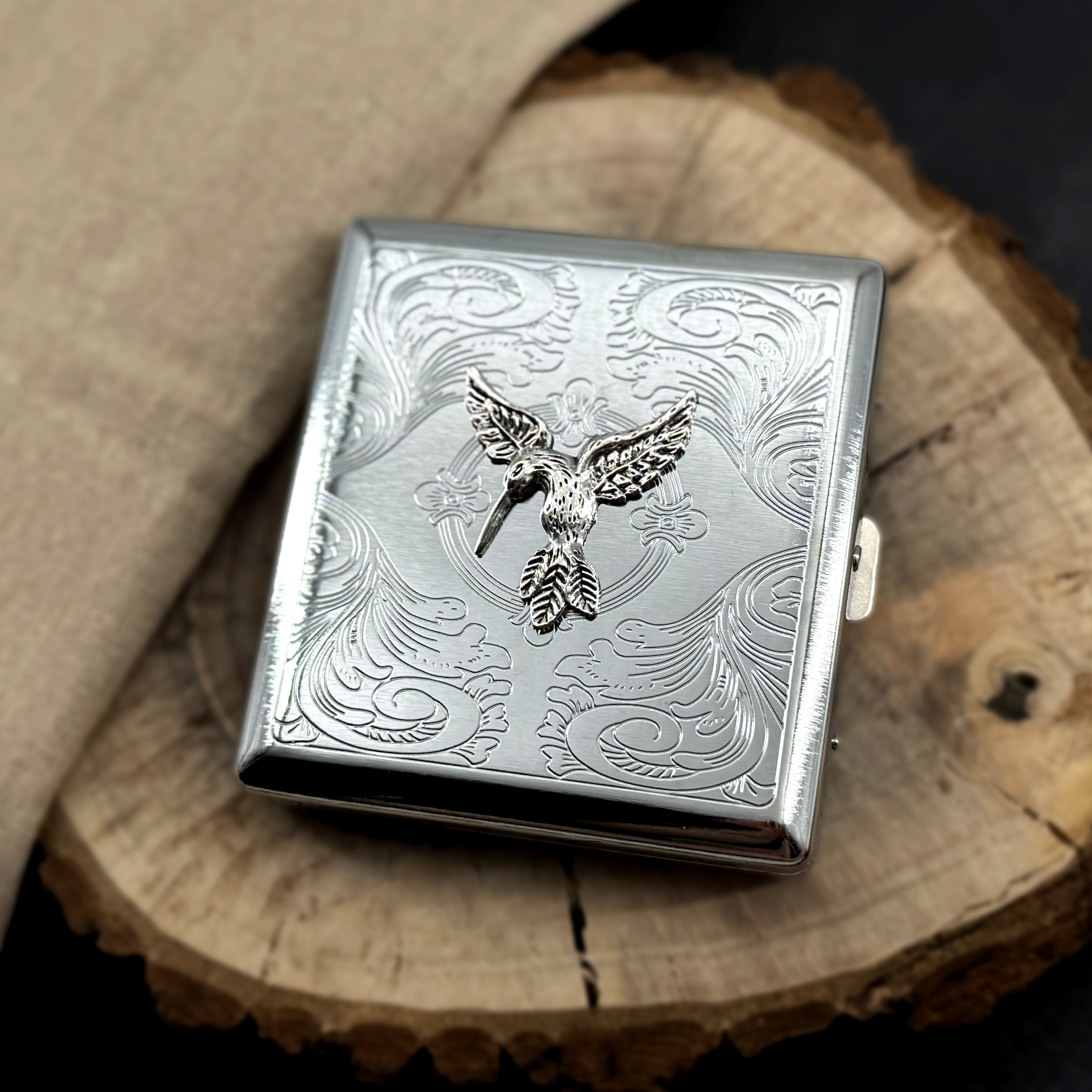 Hummingbird card holder featuring detailed bird design on engraved silver metal case
