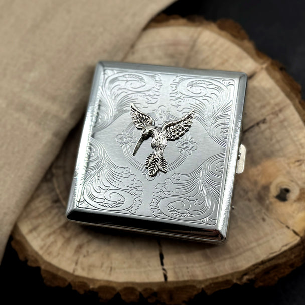 Hummingbird card holder featuring detailed bird design on engraved silver metal case
