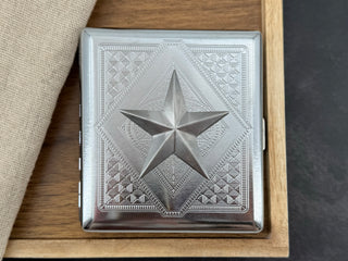 Silver nautical star cigarette case with faceted raised centerpiece