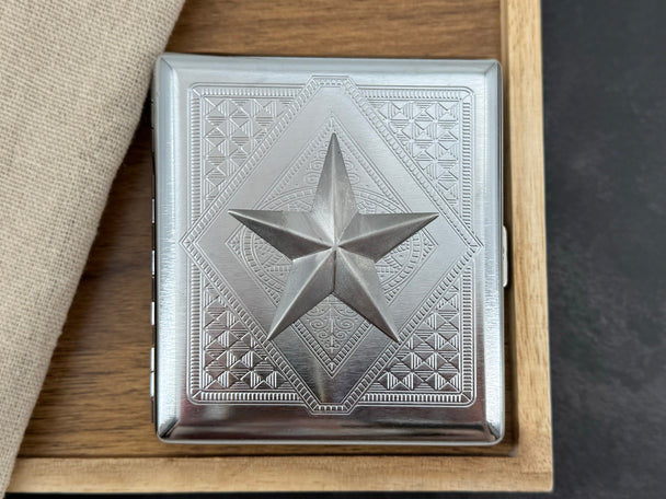 Silver nautical star cigarette case with faceted raised centerpiece