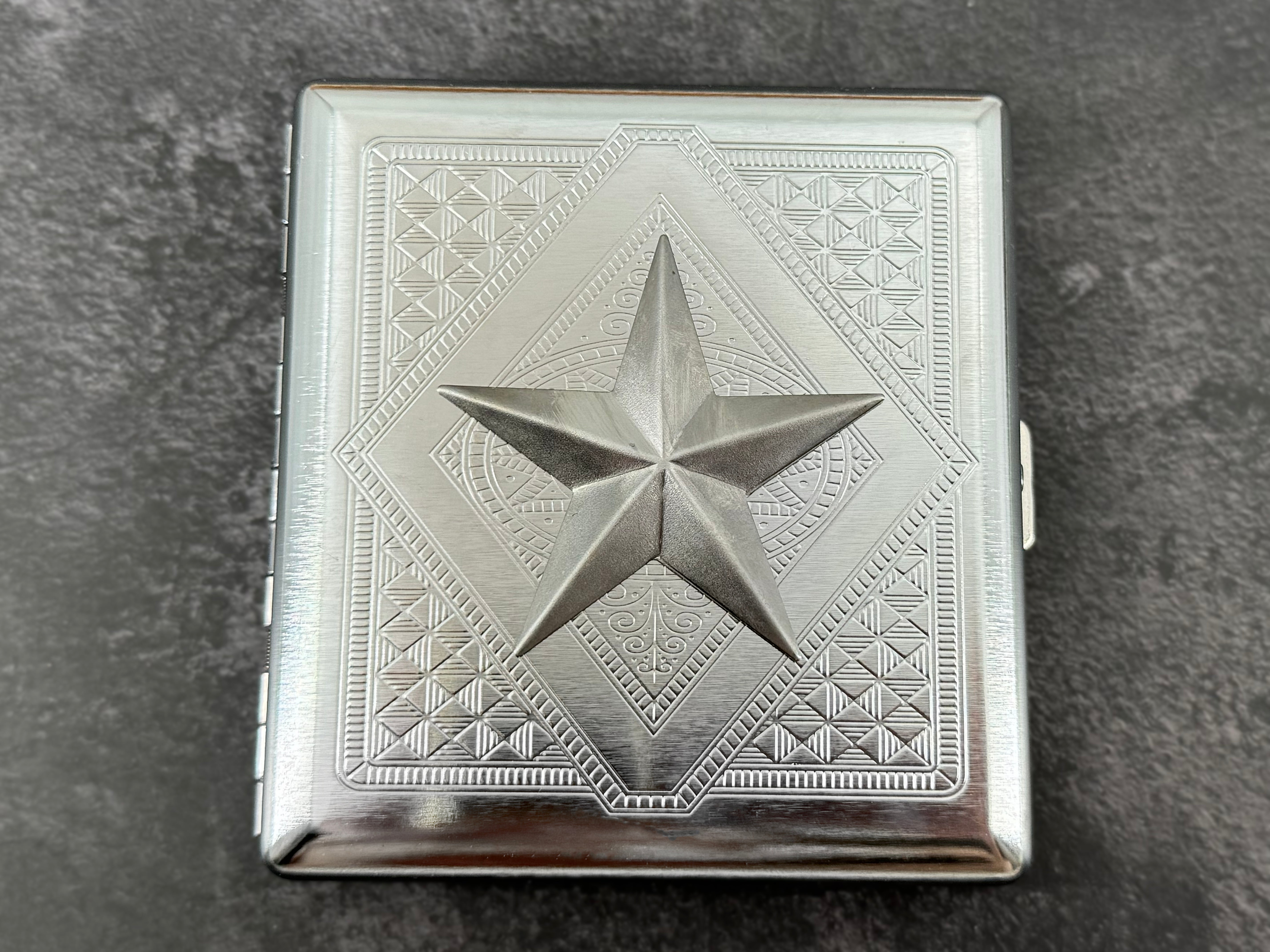 Handmade silver cigarette case featuring a raised nautical star centerpiece