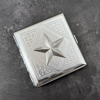 Silver nautical star metal cigarette case with detailed stamped background