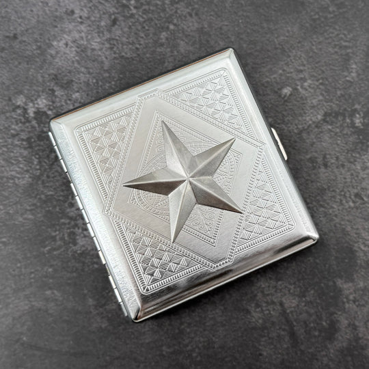 Silver nautical star metal cigarette case with detailed stamped background