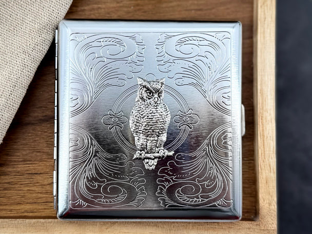 Handmade silver owl cigarette case on wooden background