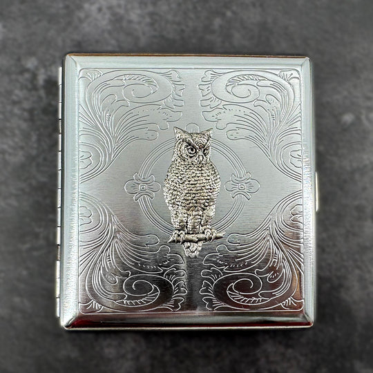 Silver owl card holder with ornate decorative metal background