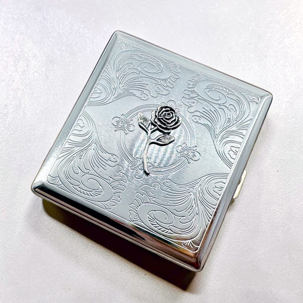 Vintage-inspired floral cigarette case with silver rose centerpiece

