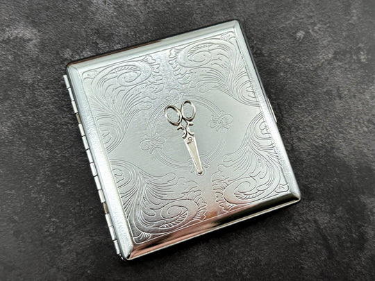 Hair stylist and sewing-inspired metal cigarette case with raised scissors design and polished silver finish