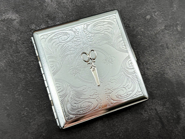 Hair stylist and sewing-inspired metal cigarette case with raised scissors design and polished silver finish