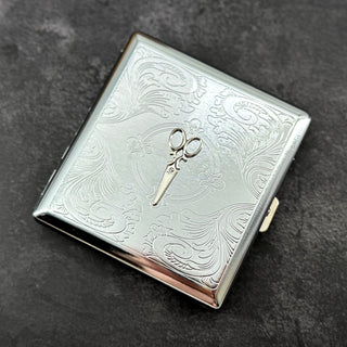 Ornate scissors business card holder with detailed stamped metal background and compact design