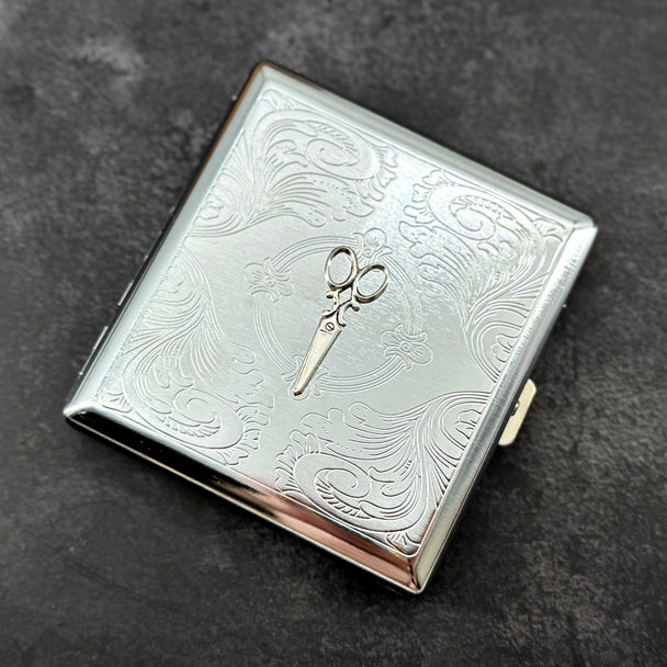 Ornate scissors business card holder with detailed stamped metal background and compact design