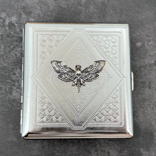 Silver skull hawkmoth metal cigarette case with detailed stamped background