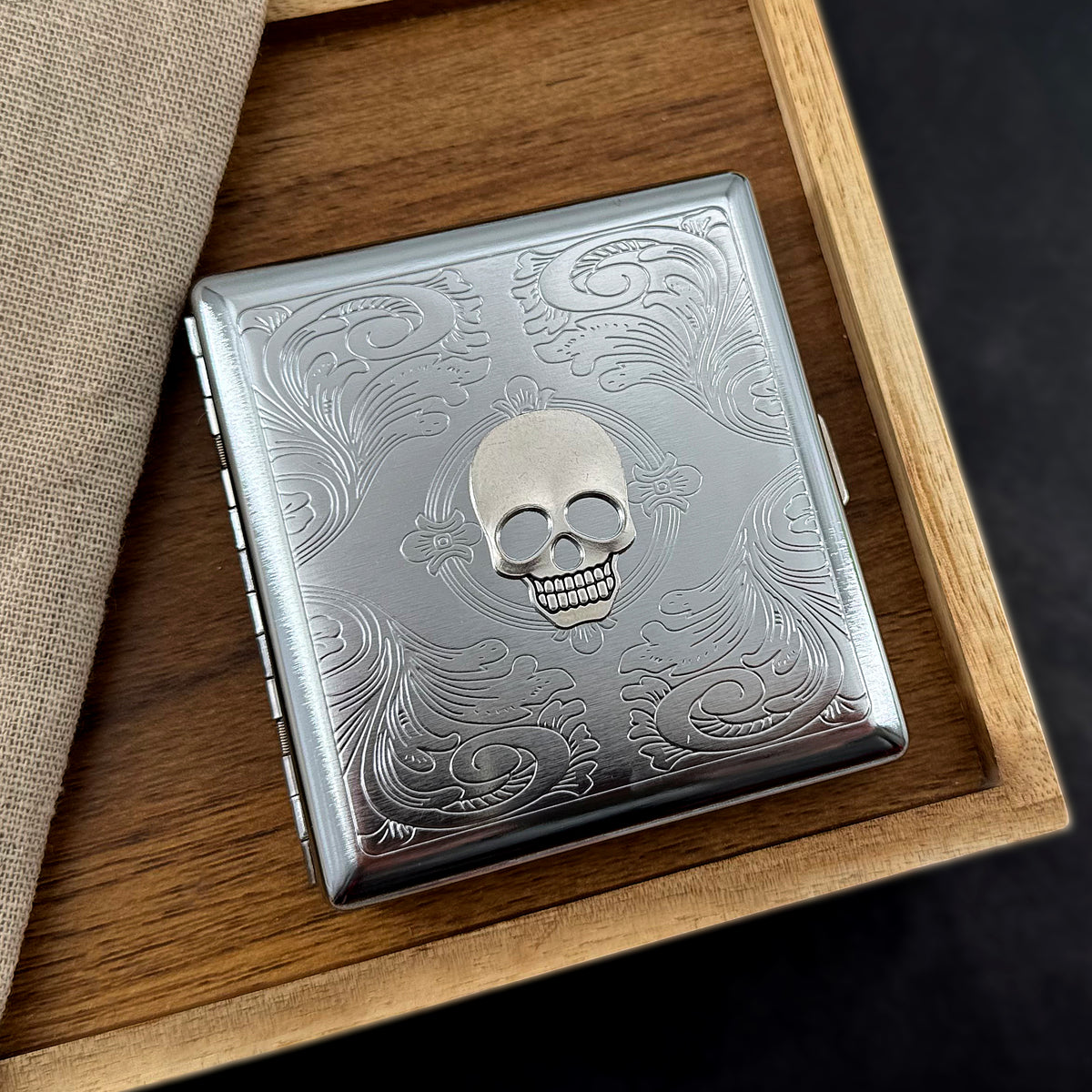 Silver skull card holder with stamped metal scrollwork