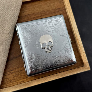 Silver skull card holder with stamped metal scrollwork
