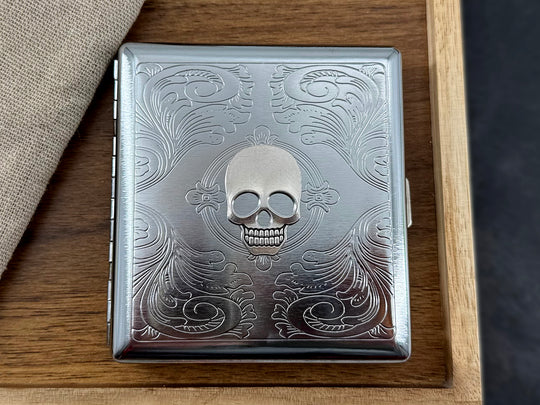Gothic metal cigarette case with raised silver skull