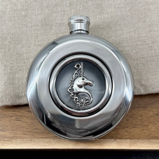 Round stainless steel flask with raised silver unicorn and clear circular viewing window