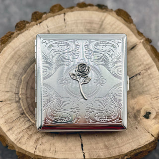 Silver rose cigarette case with raised floral detail and engraved ornamental background
