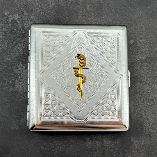 Snake and Blade cigarette case with raised gold serpent and dagger on silver stamped metal background