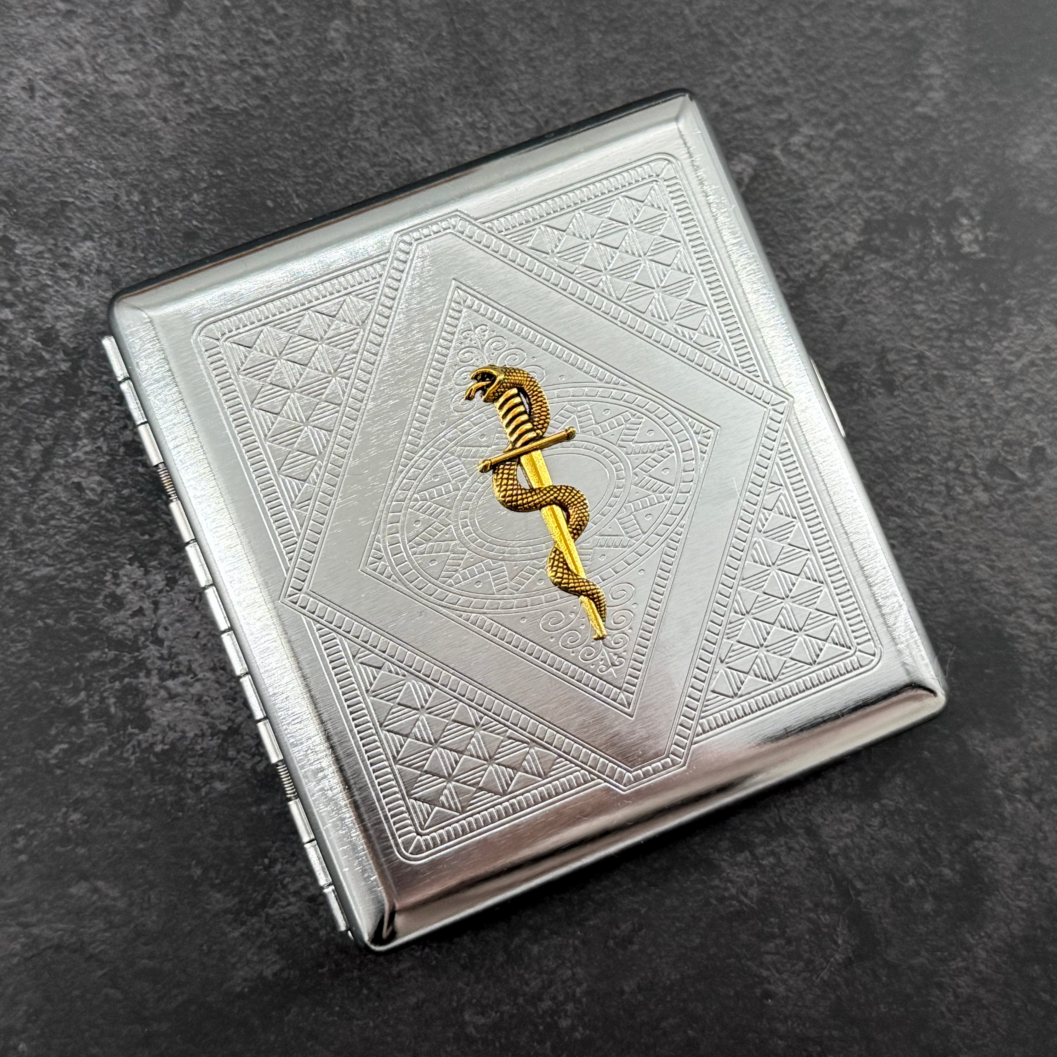 Gothic snake and dagger cigarette case closed front view with polished silver finish