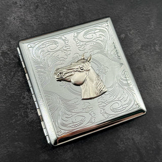 Silver stamped metal cigarette case with raised horse head and ornate scrollwork