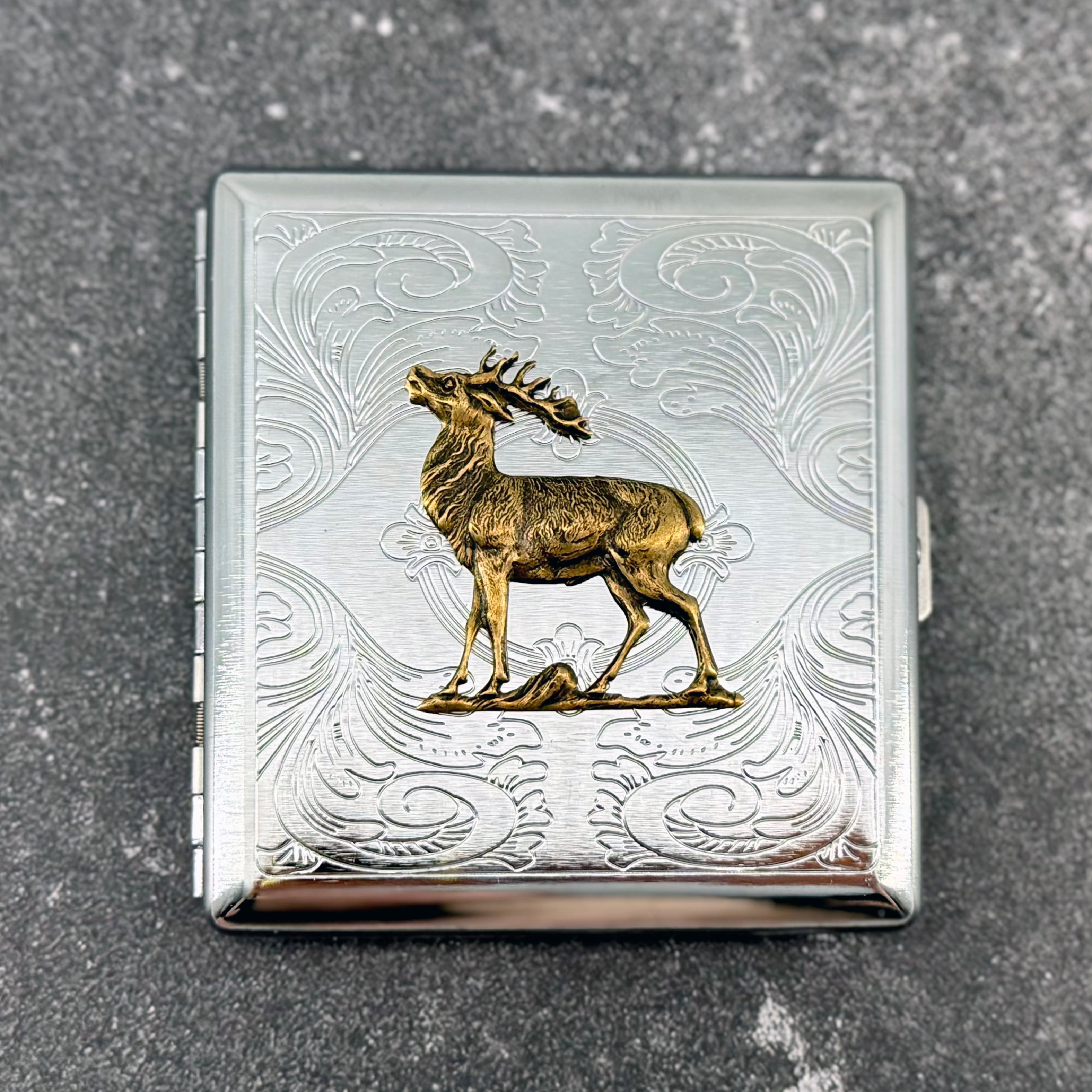 Stag pocket case with raised deer design and engraved ornamental background