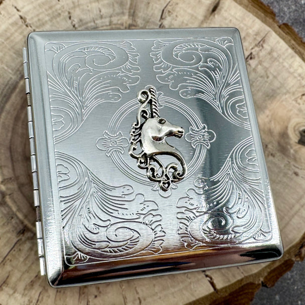 Mythical metal pocket case with unicorn design and secure snap closure