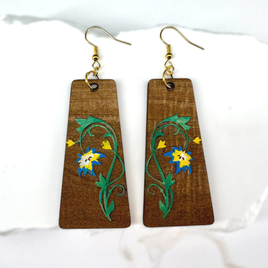 Wooden earrings with floral designs on a white background